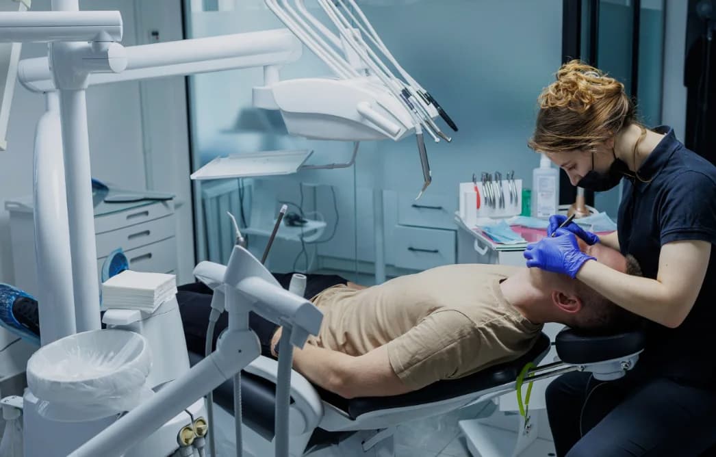 A dental clinician treating a patient in a modern surgery