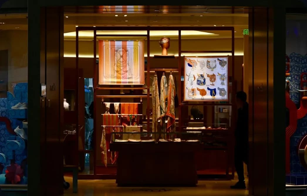 A luxury boutique storefront lit up at night