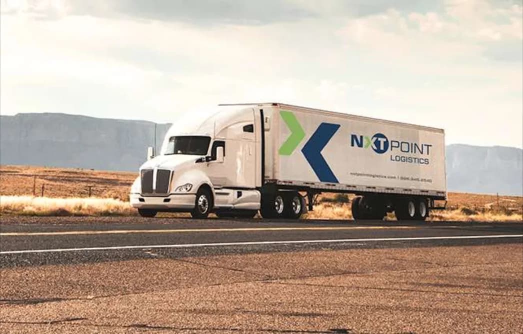 A NextPoint Logistics truck on a desert highway