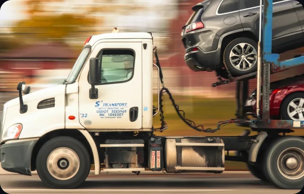 A car-carrier truck hauling vehicles down the road